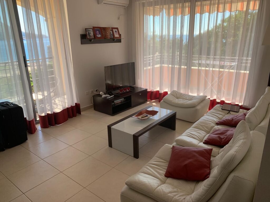Two-bedroom apartment in Becici in a complex with two swimming pools, parking and laundry.