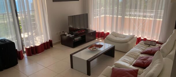 Two-bedroom apartment in Becici in a complex with two swimming pools, parking and laundry.